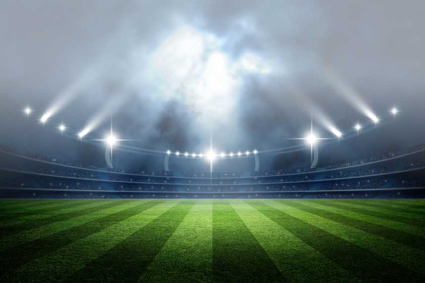 Football Stadium at Night with Floodlights Pointing Upwards