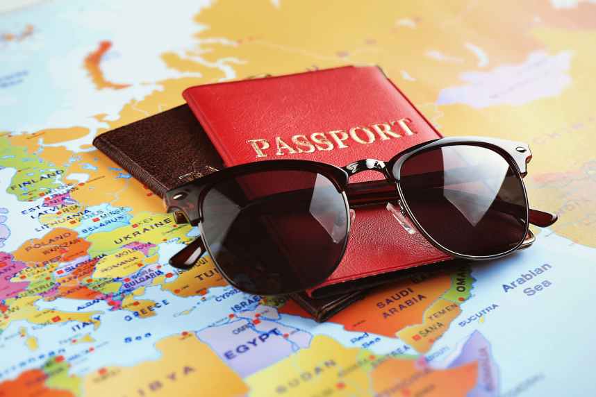 Adventure concept. Sunglasses and passports on map