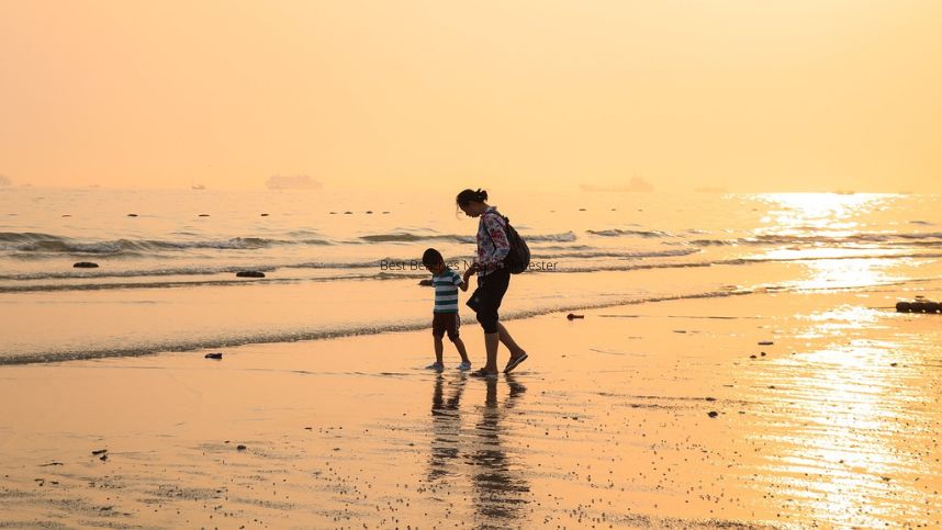 A family is walking along the beach