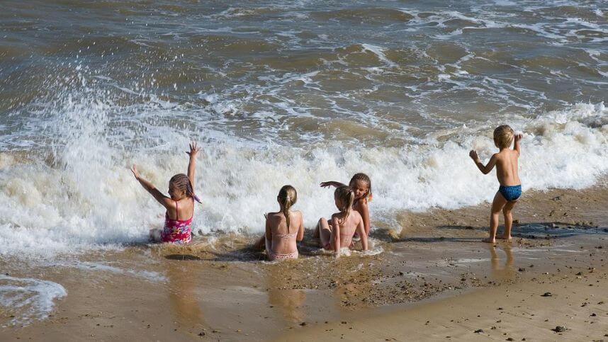 A group of children are having fun at the beach